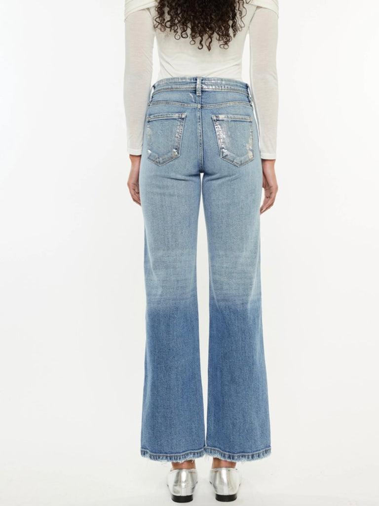 Wide Leg Kancan Jeans features whiskering, minimal distress, 5-pocket style, one button closure, and zip fly