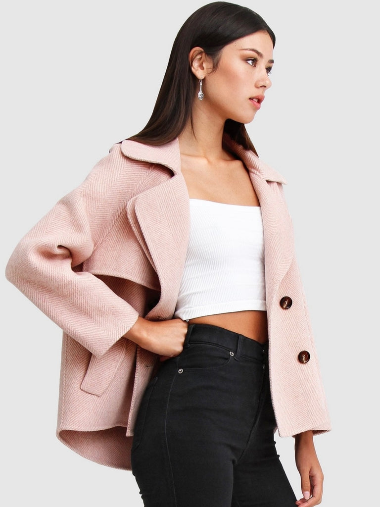 Pink Wool Blend Peacoat, featuring Oversized, cropped fit with large notch lapels, Double-breasted with flap side pockets and , eye-catching novelty buttons. 