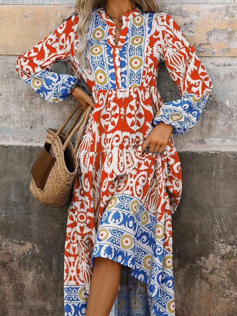  Long Boho Maxi Dress, in a beautiful Spanish print, with a Unique Geometric Pattern, accented by vibrant orangey-red and blue motifs.