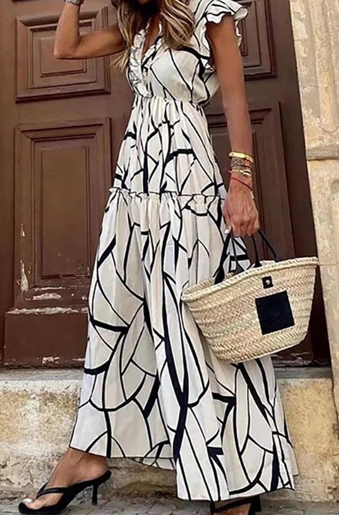 Maxi Dress with a bold black and white print, V-neck cut, and tiers of ruffles, and elastic waist.