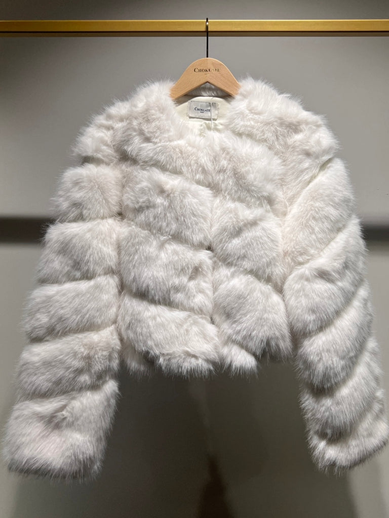 White  , Short faux- fur jacket features soft faux fur with a sleek, diagonal seam , and front button closure for easy fastening. 