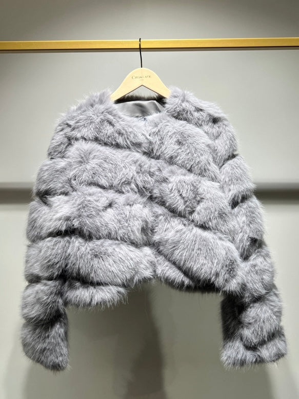 Grey , Short faux- fur jacket features soft faux fur with a sleek, diagonal seam , and front button closure for easy fastening. 