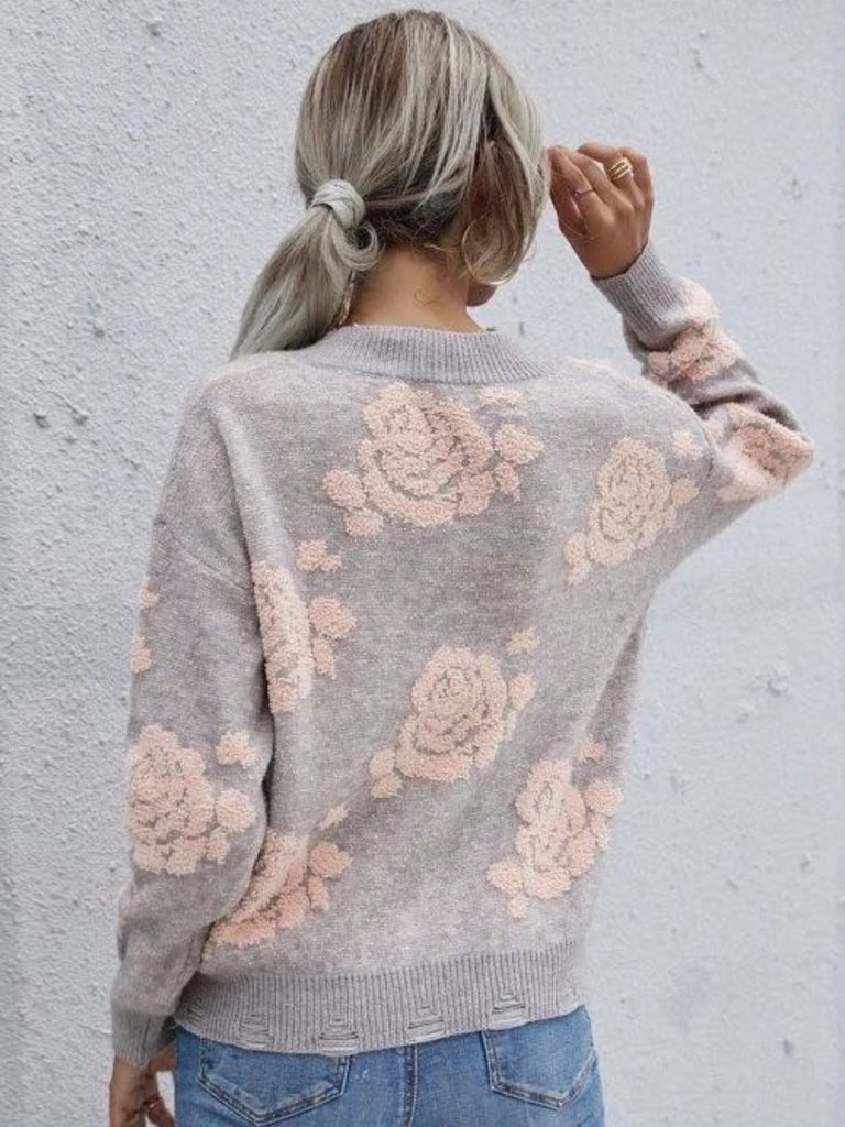 Rose Print Design SweaterThis beautiful grey sweater is adorned with soft pink rose prints throughout, offering a romantic and feminine touch.