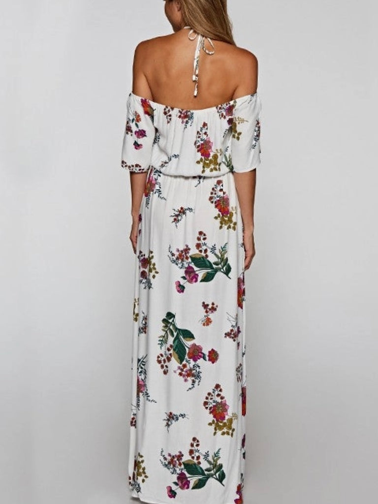 Printed Floral Maxi Dress in cream with adjustable halter tie neck off the shoulder style and front slit detail.