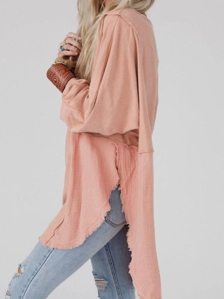 Pink Colour high-low tunic length and split hem pullover, features a round neckline and long sleeves, blend of crinkled gauze and knit, and raw edge design.