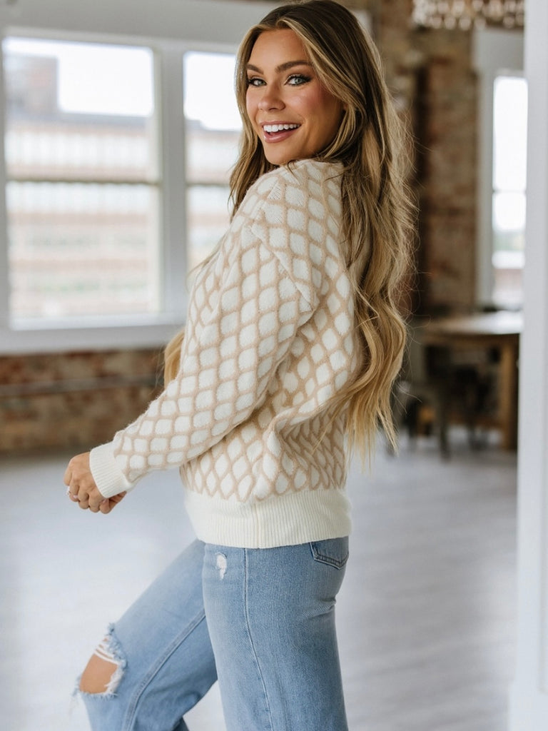 Cream and Beige Argyle pattern  Sweater has a soft rib-knit texture .