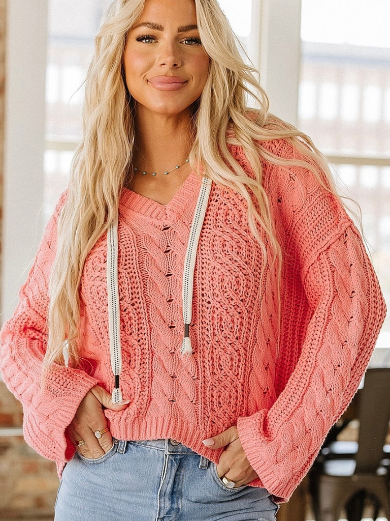 Coral  Cropped cable knit hooded sweater, the drawstring allows for an adjustable fit.