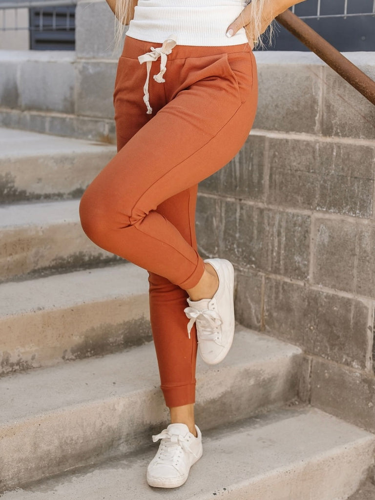 Orange Coloured Ultra Soft Fleece Joggers with tie waist and triple stretch feature for comfort.