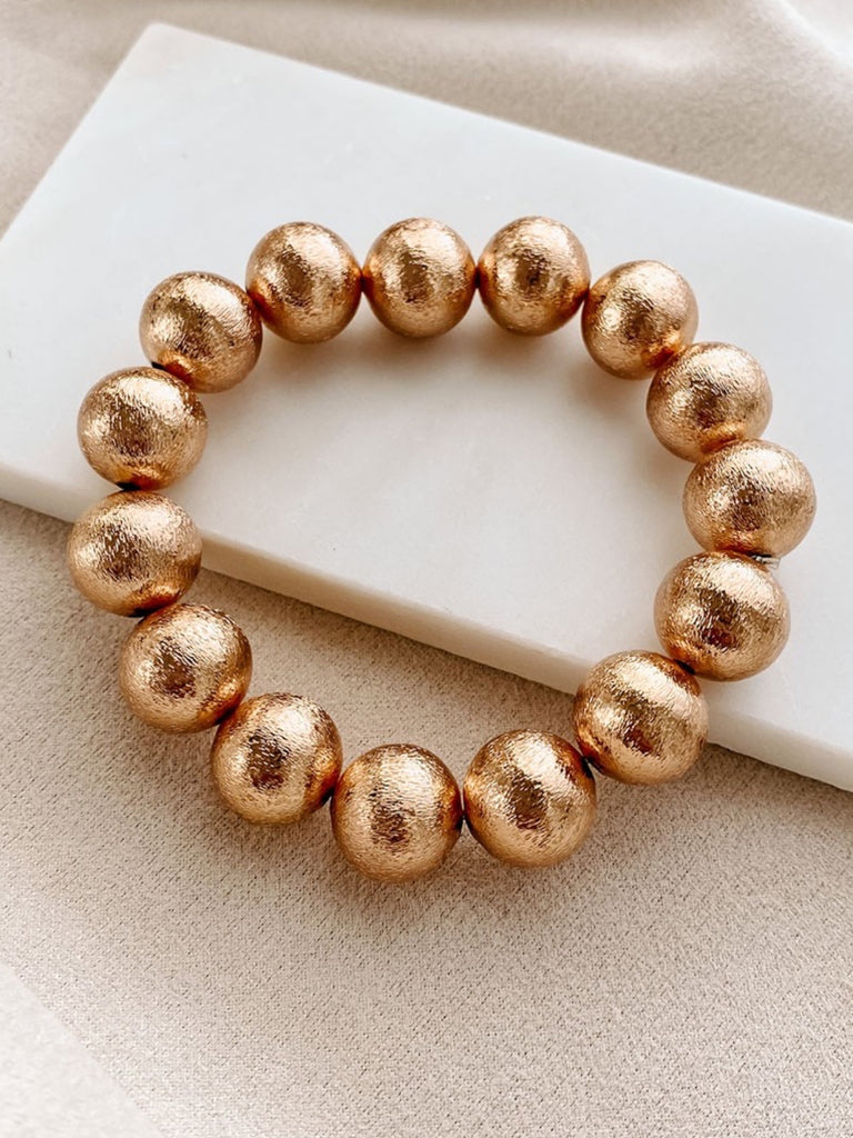 Gold Oversized Bead Bracelet made of iron, brass and wood has adjustable closure for the perfect fit.