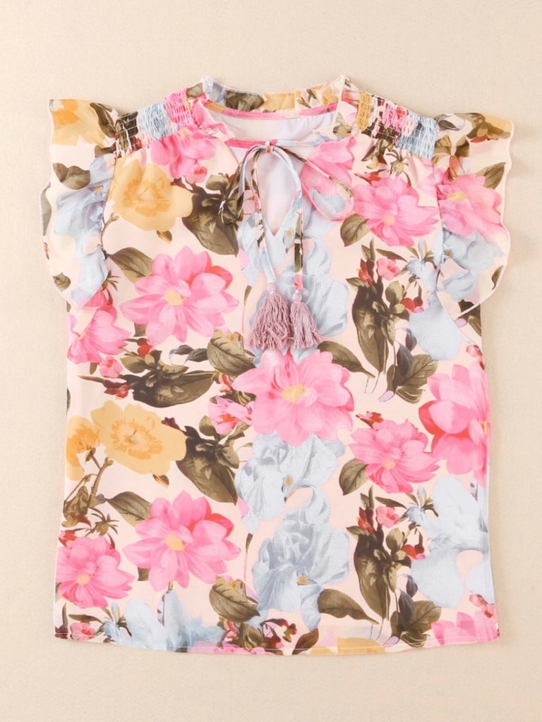 Floral Blouse Blouse features a delicate and feminine floral print, ruffled neckline, and tasseled tie neckline. 