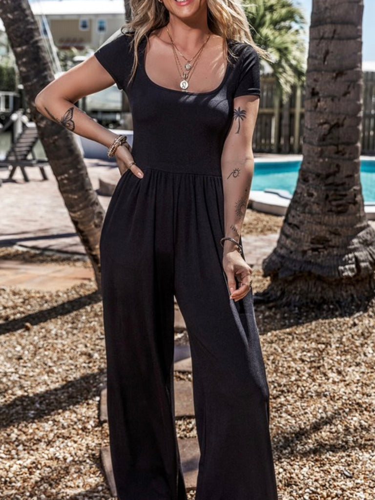   Black Pleated front  Jumpsuit, features a sophisticated U neckline and short sleeves.