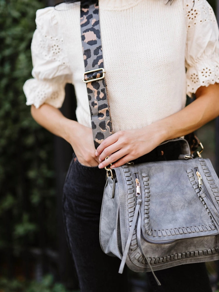 Leopard Adjustable Strap Vegan leather purse in Grey with gold hardware and 2 zippered pockets .