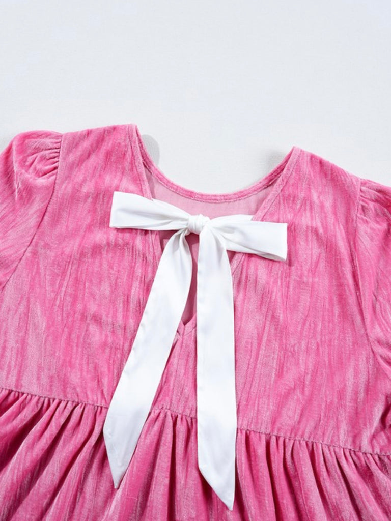 Blush Pink Velvet Dress,  white ribbon, that ties in a bow at back and tiered ruffles with flouncy sleeves .