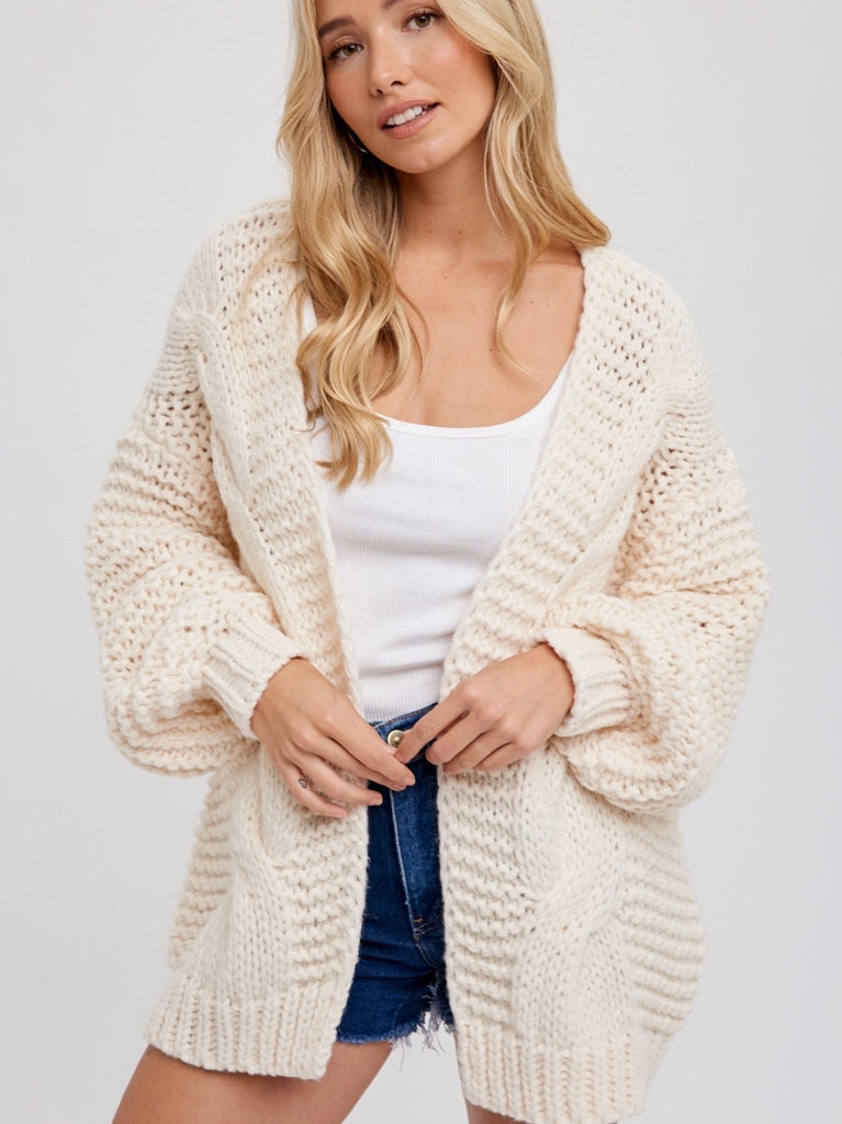 Cream Chunky Cable Cardigan with long batwing sleeves and unique braid pattern, it's an oversize fit.