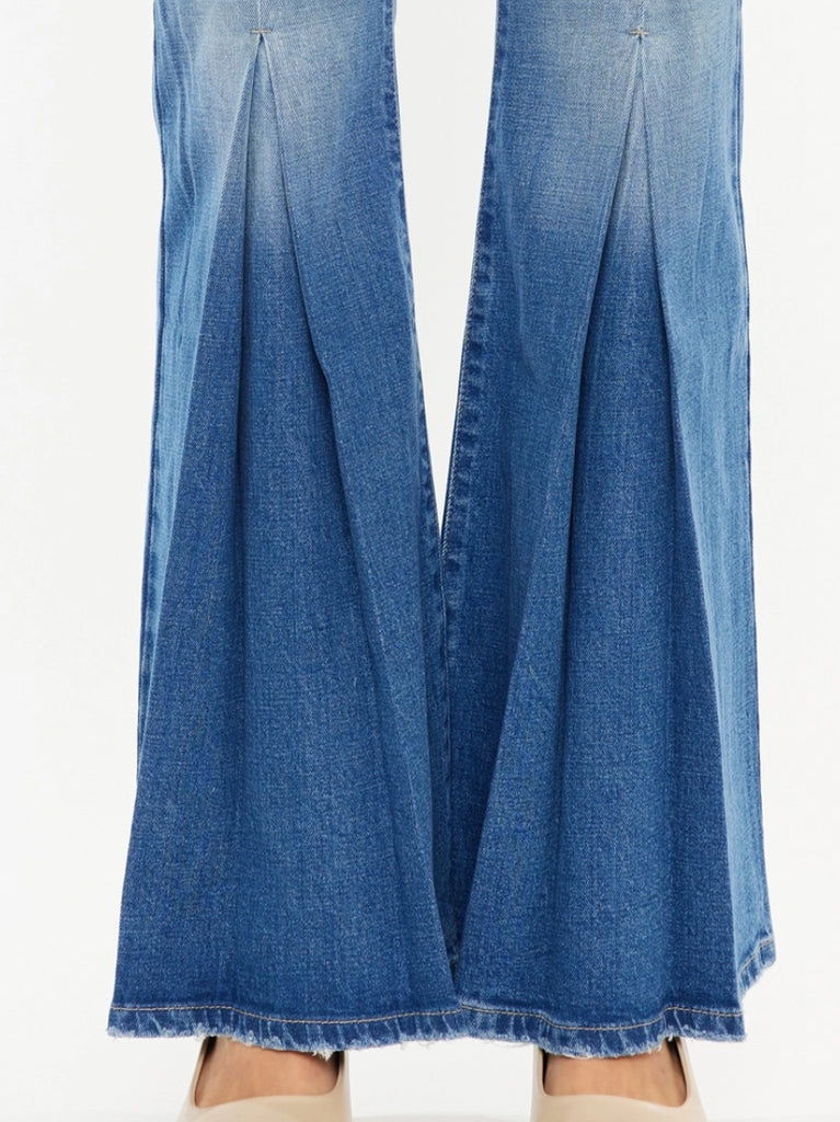 High Rise Flare Jeans with wide leg pleats detail and 5 pocket style, single-button closure, and zip fly.