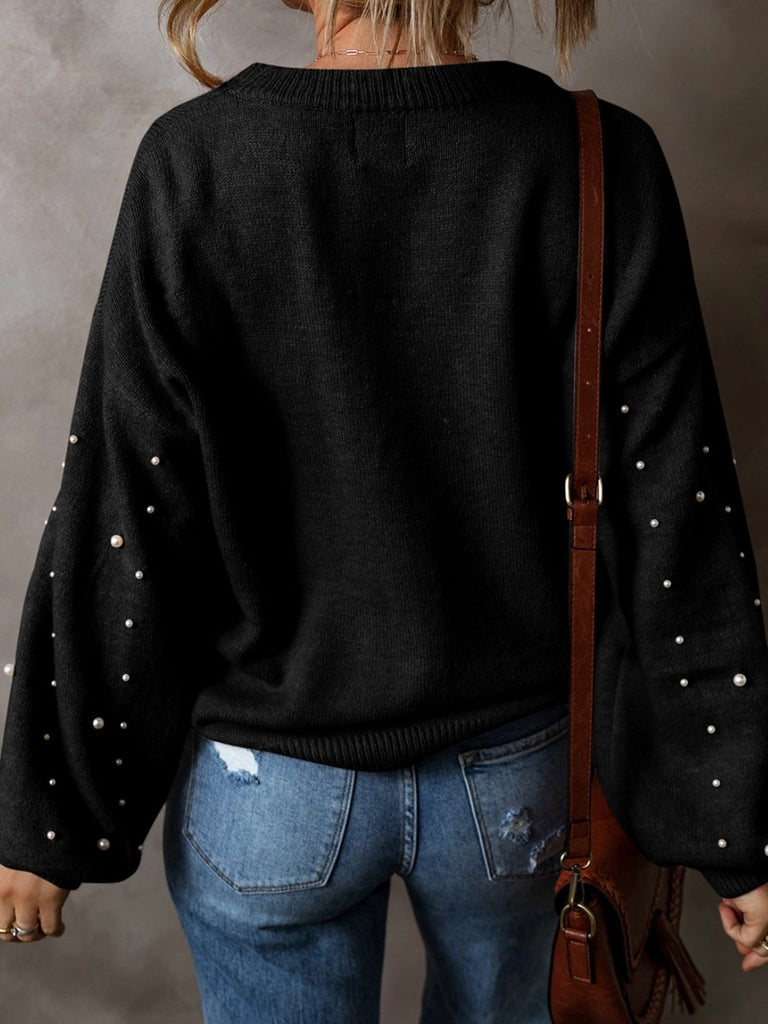 Black colour sweater with white pearls throughout, with a drop shoulder design and classic round neck .