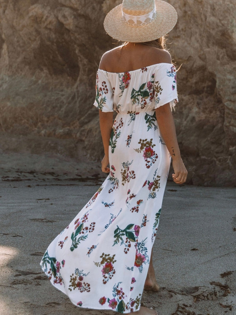 Printed Floral Maxi Dress in cream with adjustable halter tie neck off the shoulder style and front slit detail.