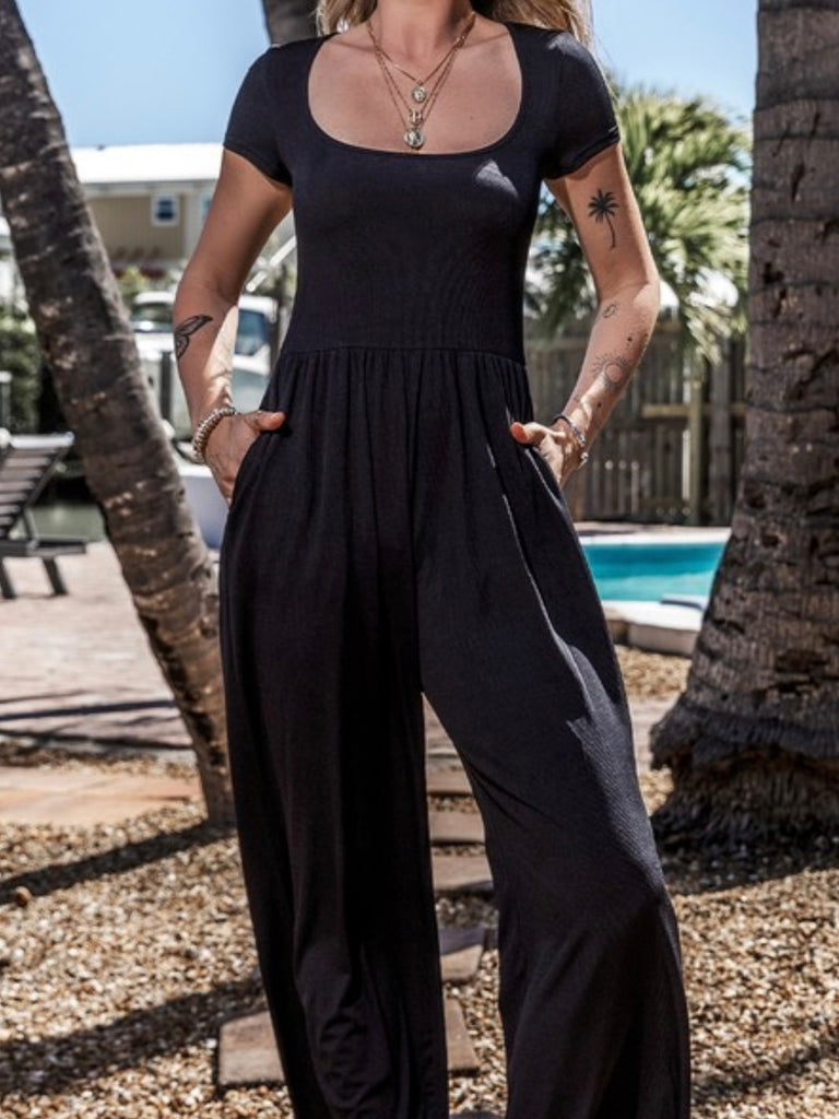 Black Pleated front Jumpsuit, features a sophisticated U neckline and short sleeves.