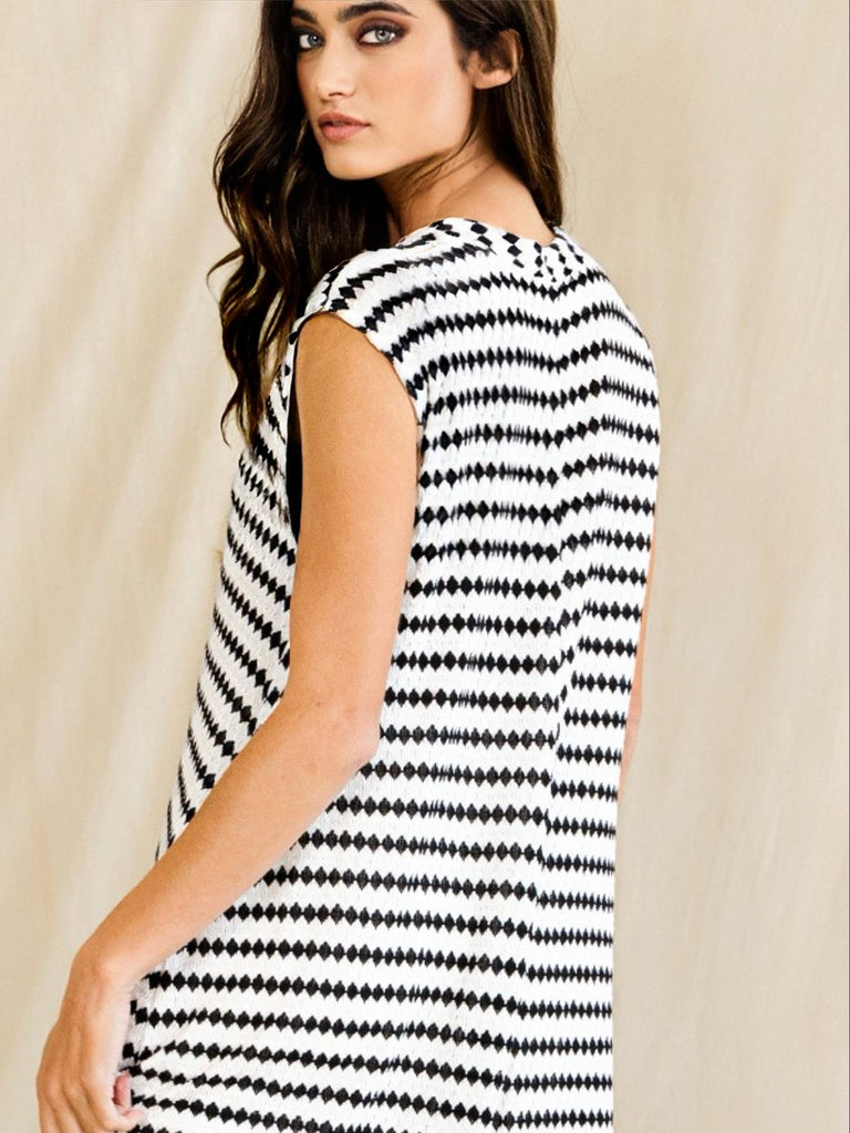 Black and white striped jumpsuit. Sleeveless, round neck, button up and wide legged.