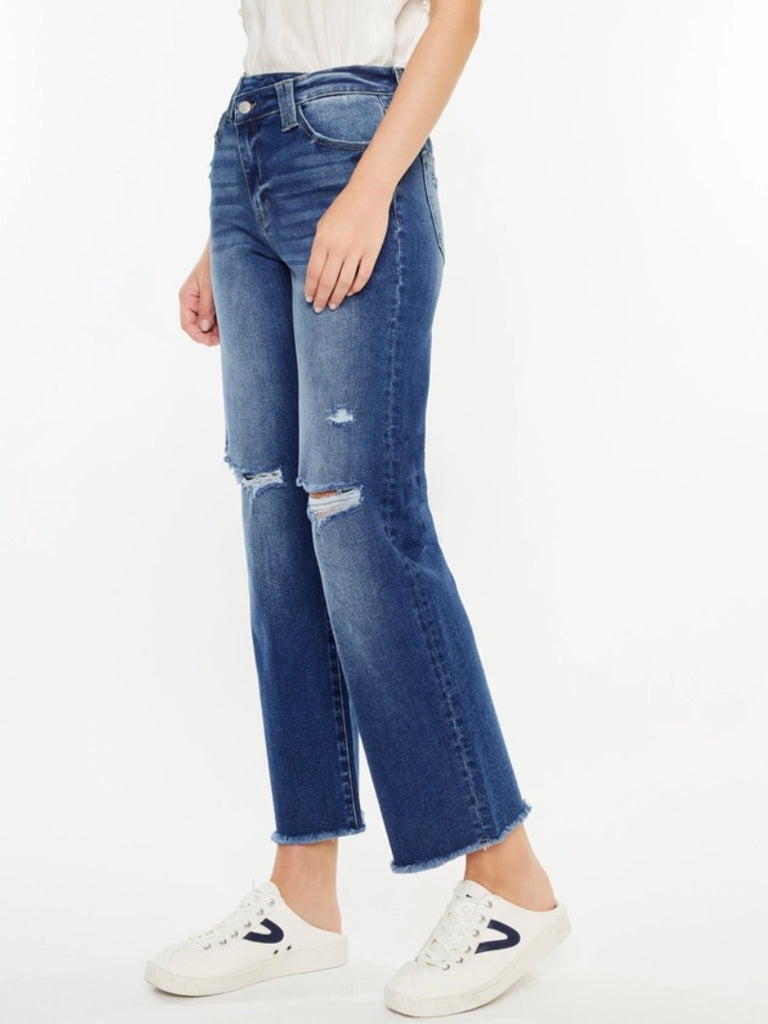 High Rise Button Closure 90's Cross Over Waist Jeans in a Dark Wash ,with whiskering details, minor distress on the knees and a scissor cut hem.