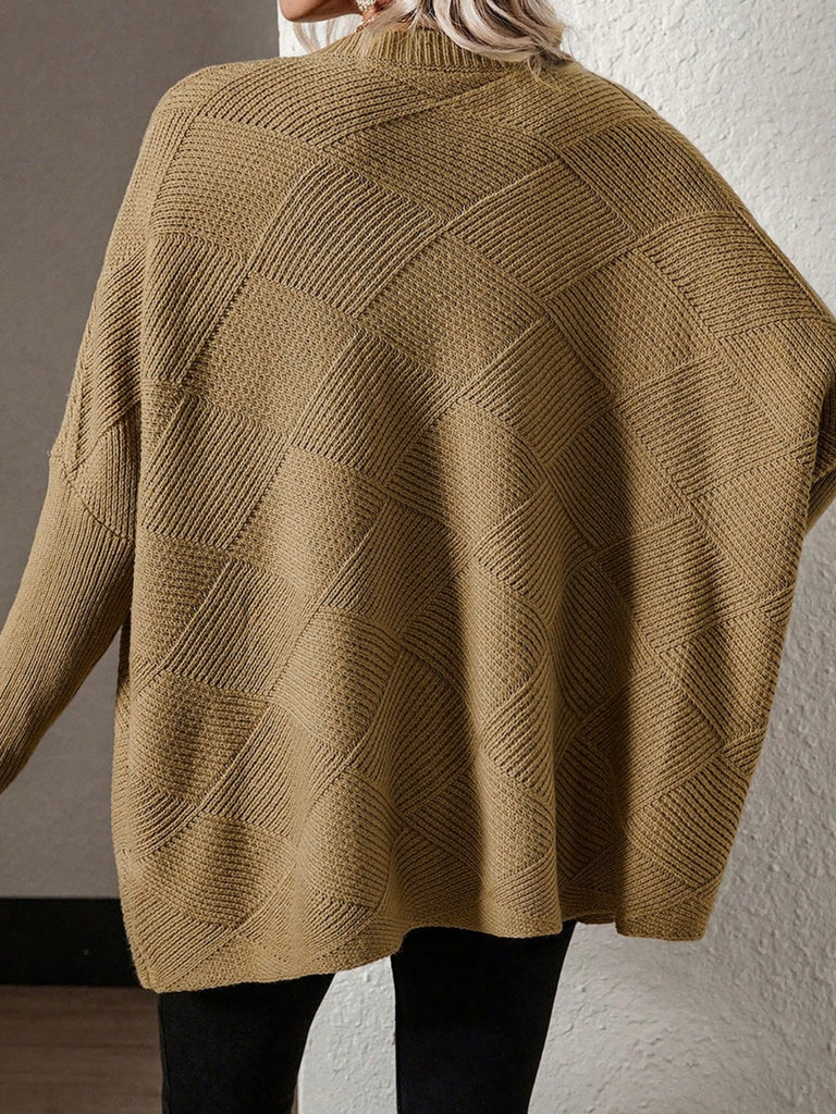 Camel oversized sweater with v-neck and batwing sleeve. A monochromatic checkered pattern. Acrylic blend