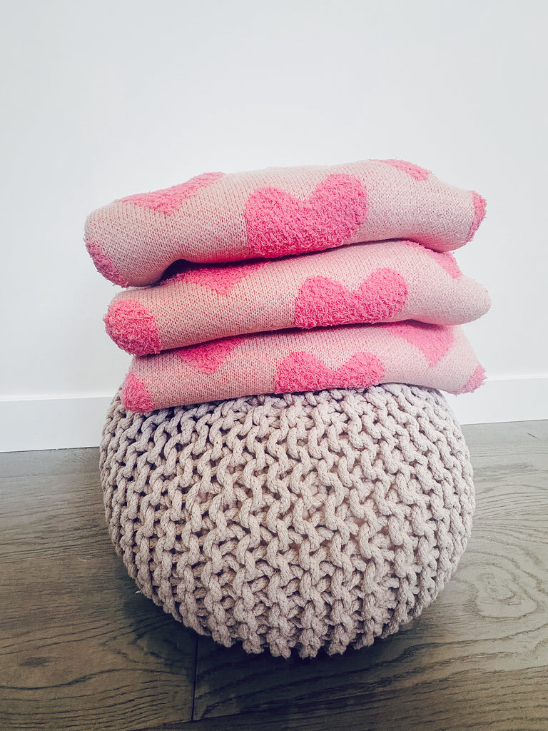 Pink sweater with contrasting fuzzy pink hearts, long sleeved.