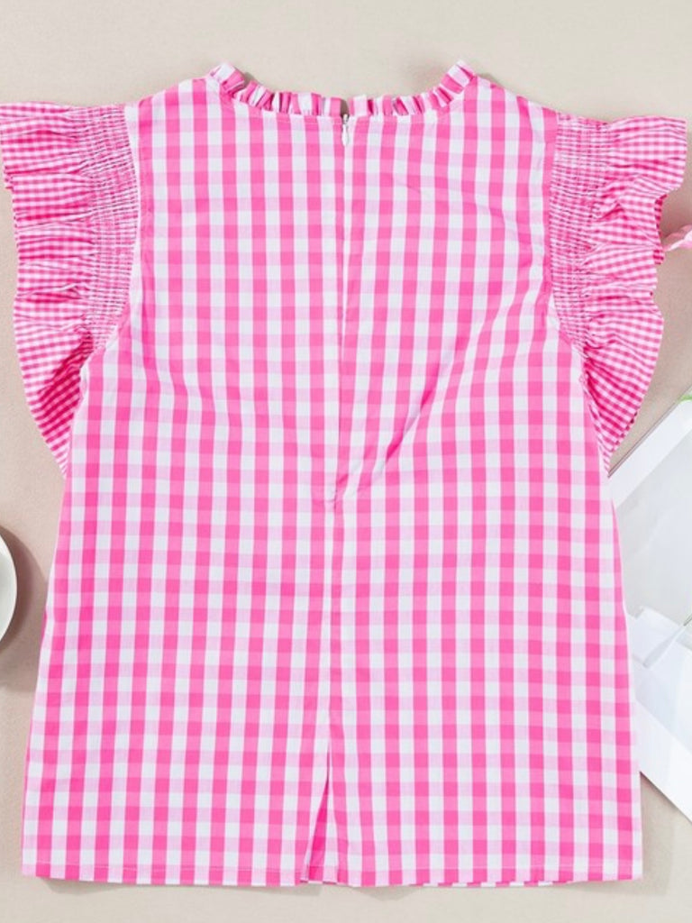 Pink Gingham Top Features a charming ruffled cap sleeve and frilled neckline.