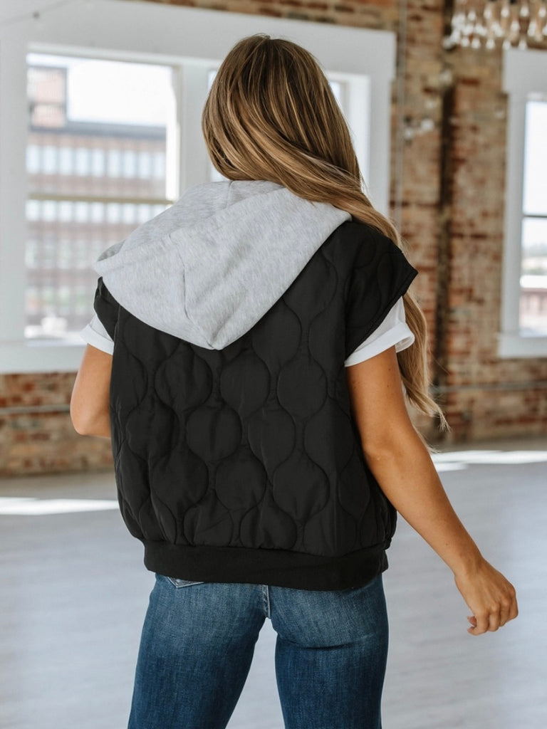 Black  ,Quilted Hooded Vest with attached grey hood for added warmth and zip style front closure.