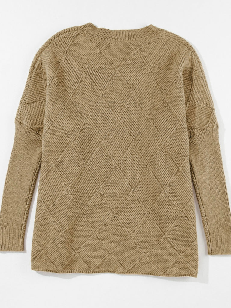 Camel oversized sweater with v-neck and batwing sleeve. A monochromatic checkered pattern. Acrylic blend