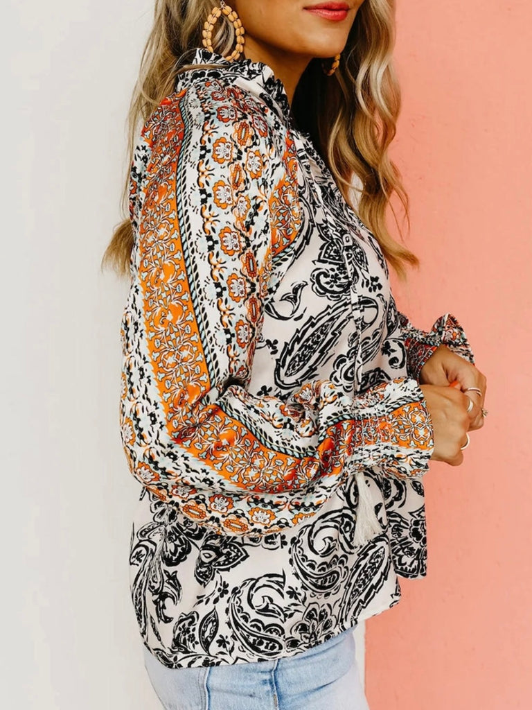 Flouncy  V-neck Sleeved ,Blackened Paisley Print Top. Featuring a striking black and white paisley print throughout, and a bold orange boho stripe detail on the sleeves, creating a stylish contrast.