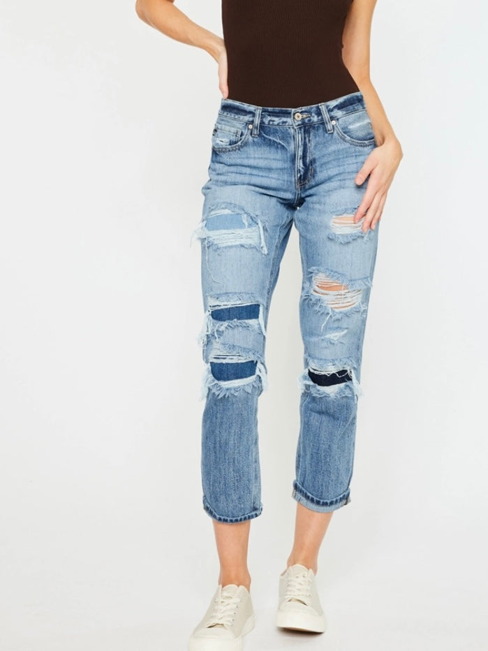 High Waisted ,5 Pocket Single Button Front and zip-fly Jean, with Light Fading and 3d Whisker detail , and moderate destruction with patches on both legs .