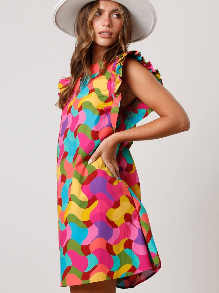 Shift Dress, featuring a vibrant geometric print ,made from soft and breathable 100% cotton, this dress also boasts smocked short ruffle sleeves.