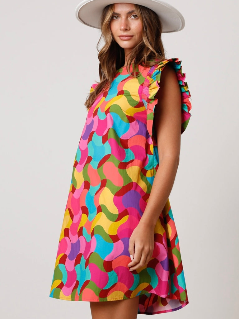 Shift Dress, featuring a vibrant geometric print ,made from soft and breathable 100% cotton, this dress also boasts smocked short ruffle sleeves.