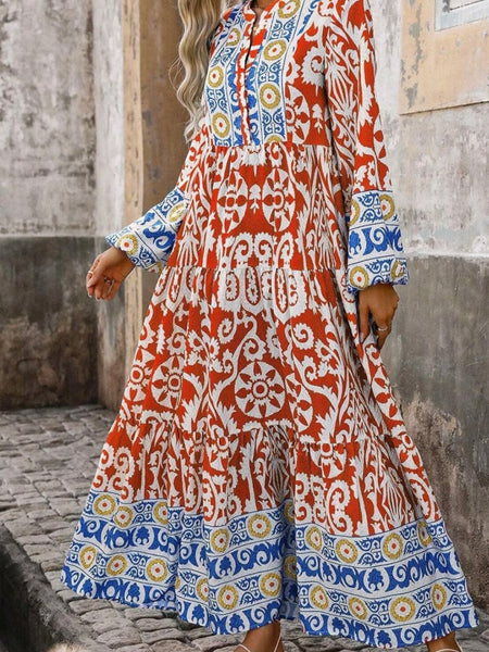  Long Boho Maxi Dress, in a beautiful Spanish print, with a Unique Geometric Pattern, accented by vibrant orangey-red and blue motifs.