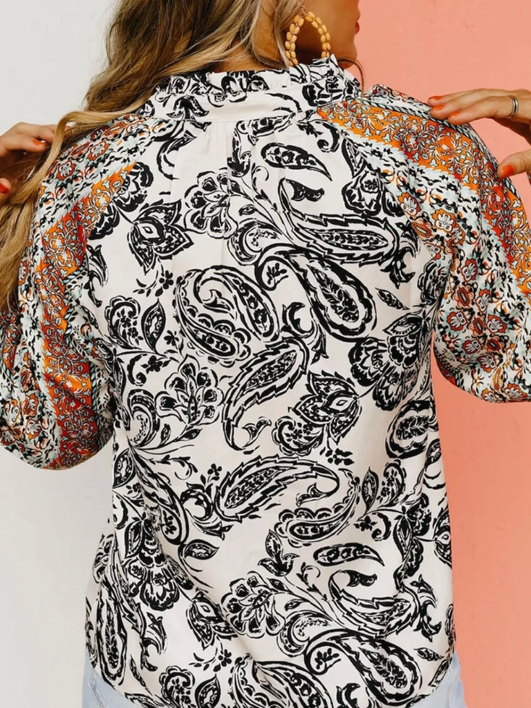 Flouncy  V-neck Sleeved ,Blackened Paisley Print Top. Featuring a striking black and white paisley print throughout, and a bold orange boho stripe detail on the sleeves, creating a stylish contrast.