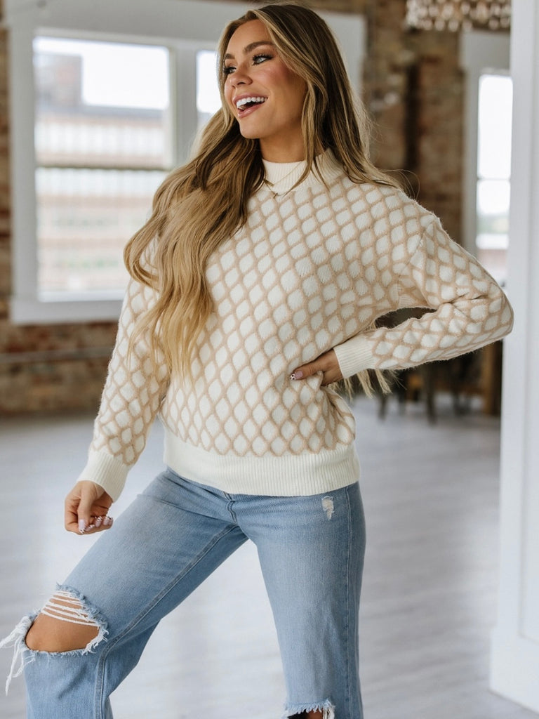 Cream and Beige Argyle pattern  Sweater has a soft rib-knit texture .