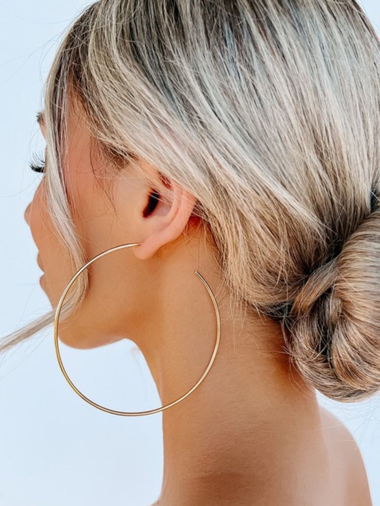 Gold Hoop Earrings, Featuring a large hoop detail , and are made with made with iron and brass.