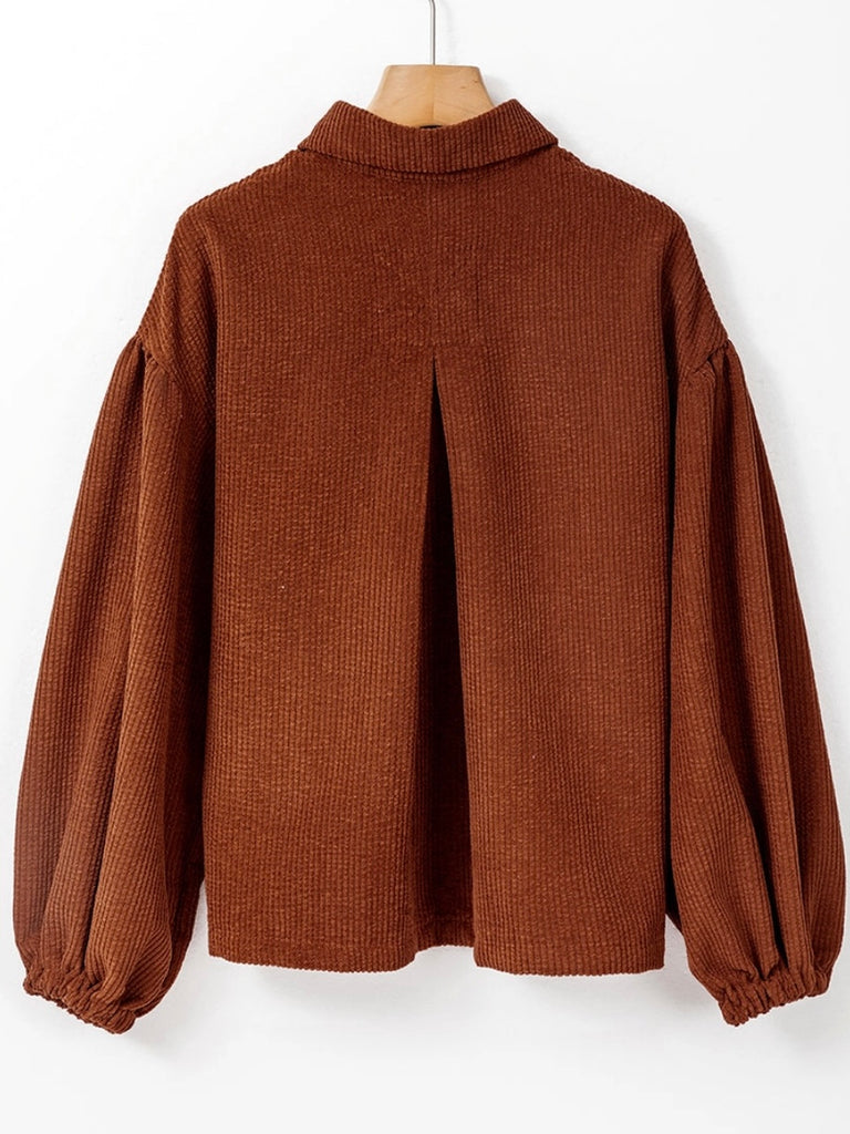 Brown Corduroy Shacket features a trendy oversized fit, with puff sleeves and a pleated back and button front.