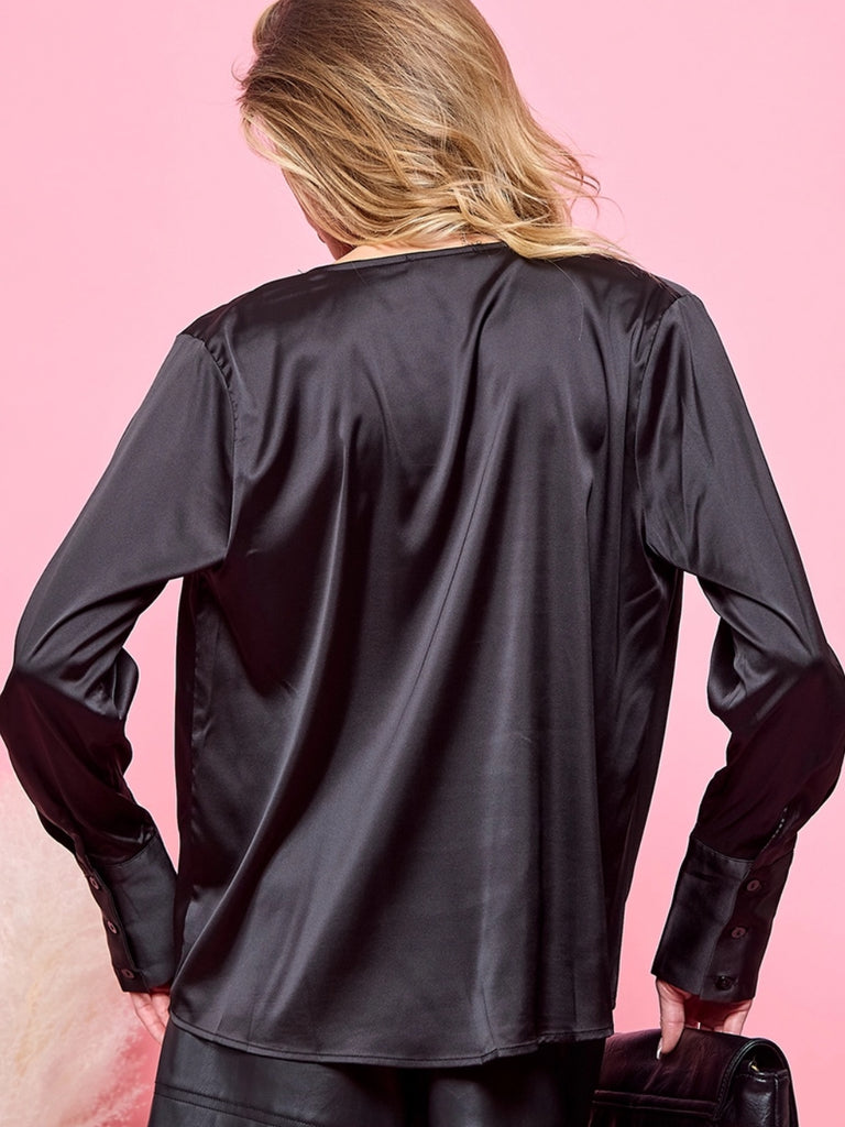 Black satiny, drape blouse with a front sway neckline. Buttons on the cuff. Made of 100% polyester, and long sleeves.