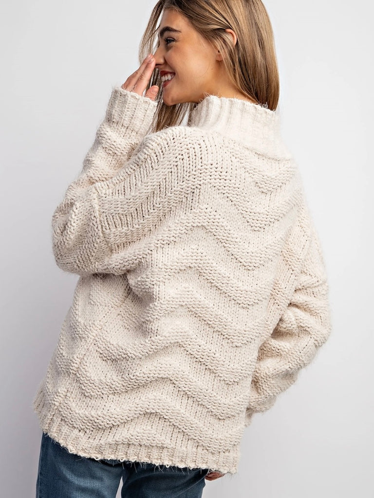 Beige Chevron Sweater ,with stretch and medium weight yarn, has a loose fit and drop shoulder design with ribbed bands.