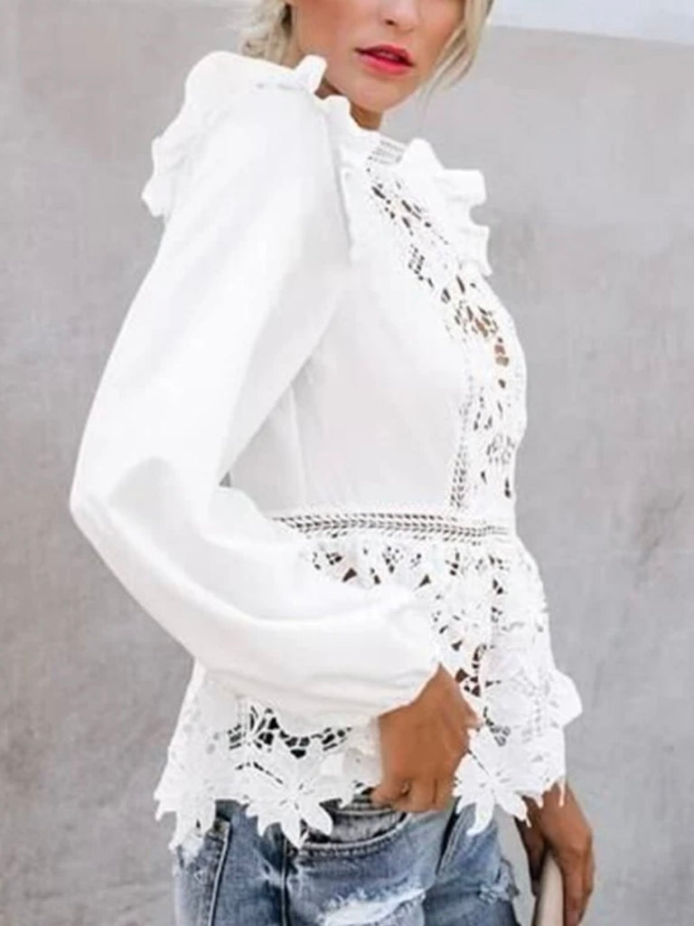 Lace Blouse in White, with ruffled shoulders and neckline and has intricate lace details .