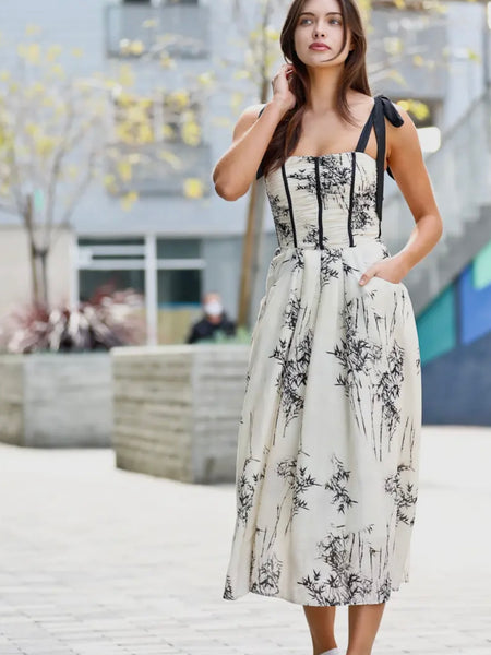 Black and white floral print Dress  features a playful off-shoulder design with tie strings ,and has front pockets, and smocked details.