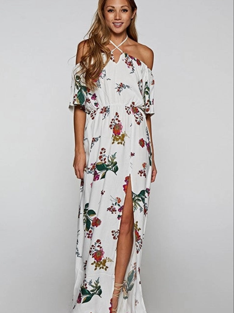 Printed Floral Maxi Dress in cream with adjustable halter tie neck off the shoulder style and front slit detail.