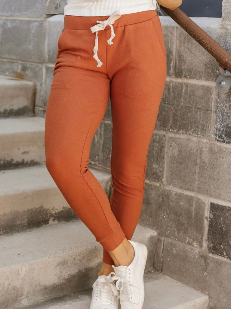 Orange Coloured Ultra Soft Fleece Joggers with tie waist and triple stretch feature for comfort.