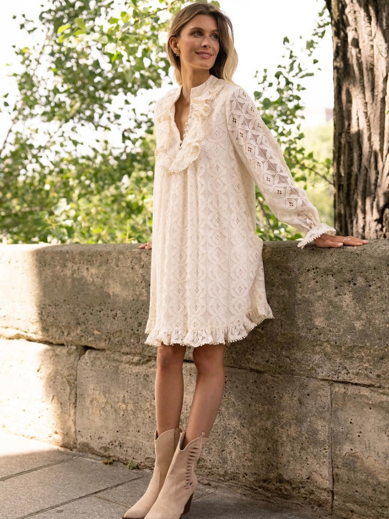 Cream Lace Midi Dress featuring a frilly collar and buttons, long ruffle sleeves, and a flared cut with ruffle details at the bottom.