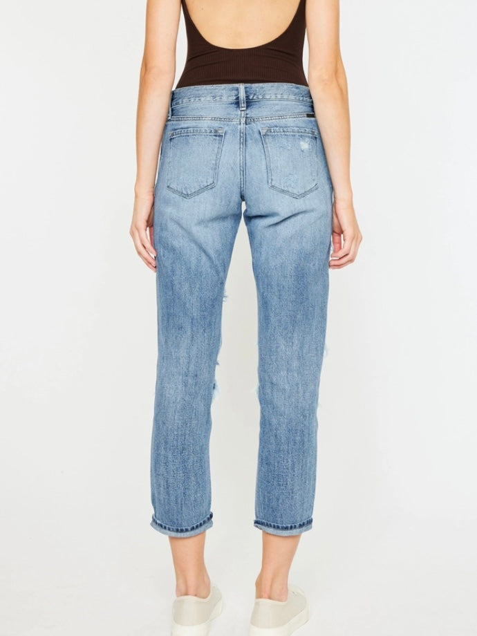 High Waisted ,5 Pocket Single Button Front and zip-fly Jean, with Light Fading and 3d Whisker detail , and moderate destruction with patches on both legs .