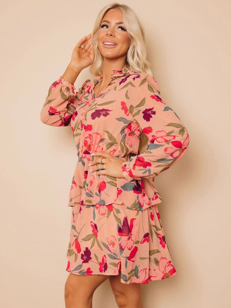 Midi Dress with tiered skirt , and v -neckline and mock button details features a frilled floral ruffle design, with a peachy pink and burgundy floral print.