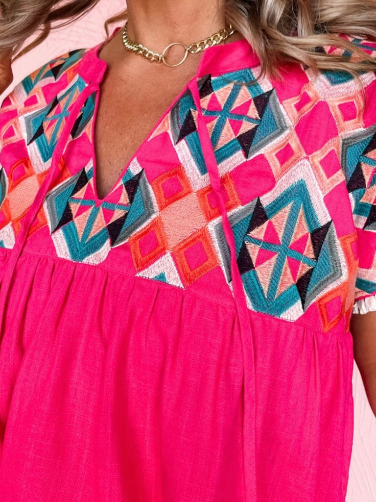 Vibrant Pink Geometric Print Top featuring intricate embroidery, and tassel ties,