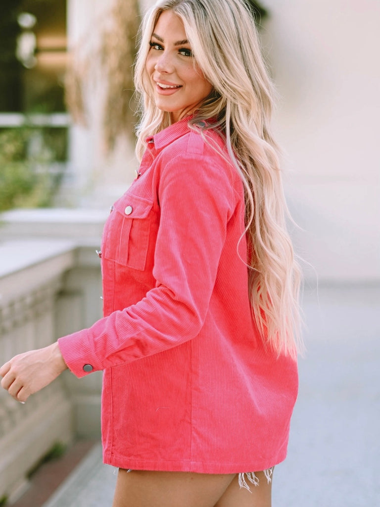 Bright pink corduroy shacket features a button front and front pockets.