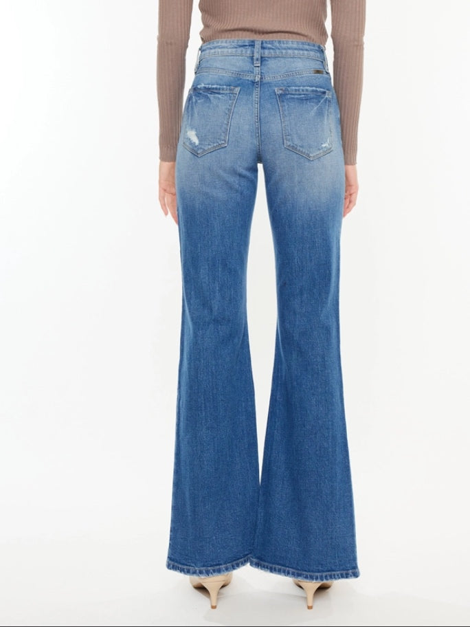 High Rise Flare Jeans with wide leg pleats detail and 5 pocket style, single-button closure, and zip fly.